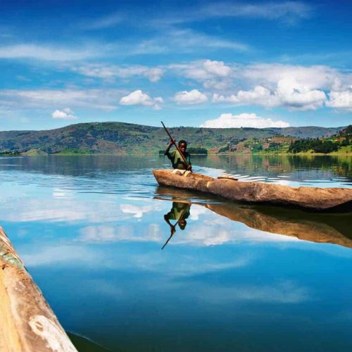 A boy rides a canoe on Lake Bunyonyi